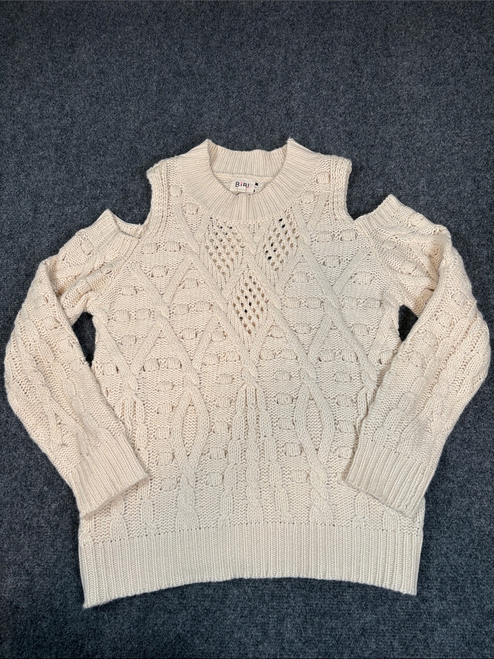 BiBi Cream Cold-Shoulder Cable Knit Sweater
Size: Medium